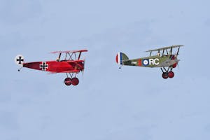 Vintage WWI biplanes soar over Titusville, Florida's clear skies capturing historical aviation moments.